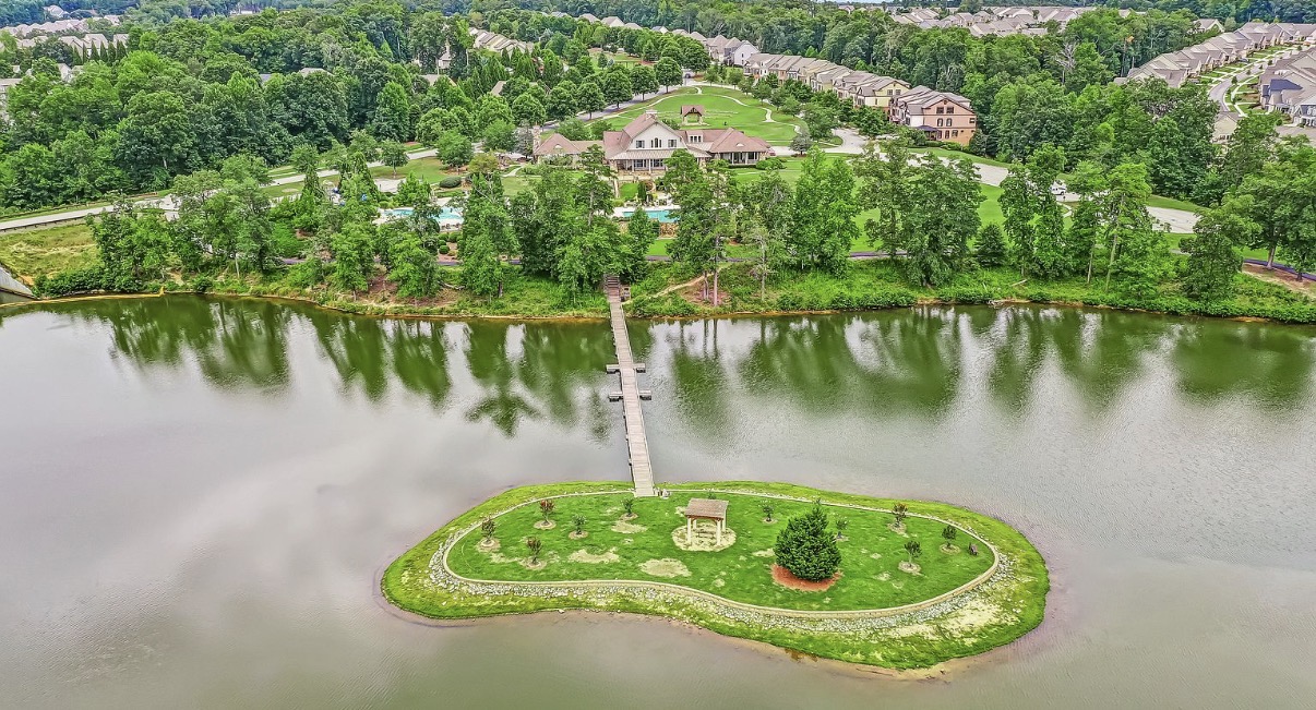 Sterling on the Lake community lake and landscaped island with footbridge
