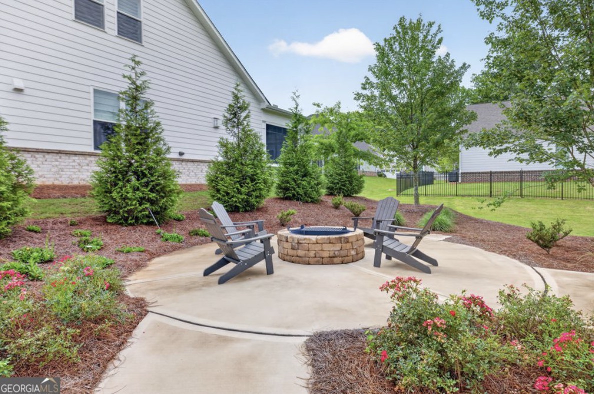 Community fire pit with Adirondack chairs at Courtyards at Tradition