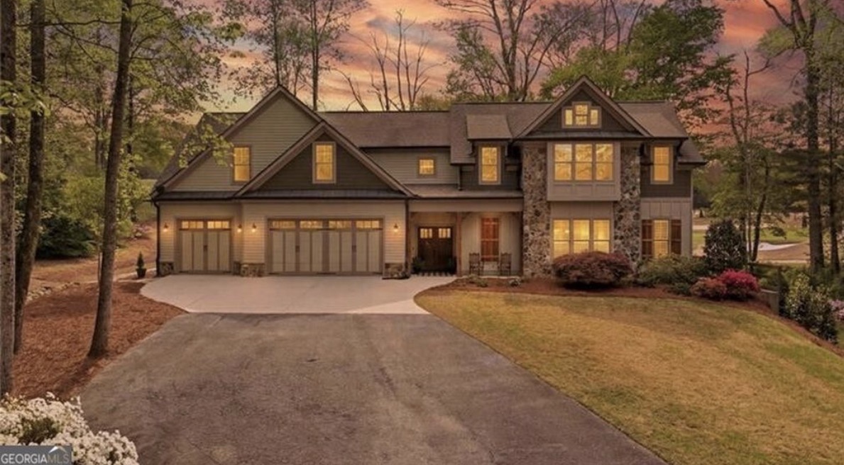 Royal Lakes home with a three-car garage photographed at dusk