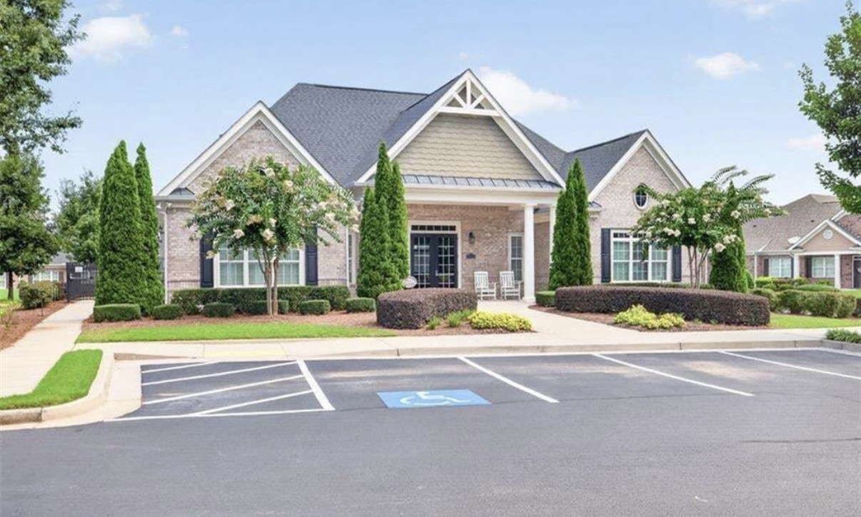 The Orchards of Park Ridge clubhouse with front porch and rocking chairs