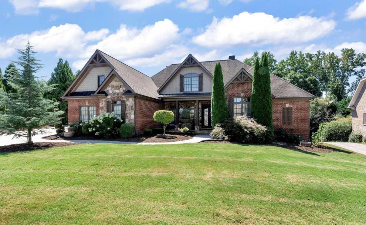 Brick and stone ranch-style home in The Hedgerows