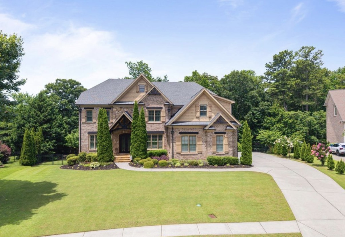 Two-story brick home with a landscaped front yard in Hamilton Mill
