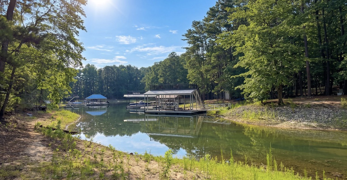 Tree-lined Lake Lanier cove with docks visible across the water