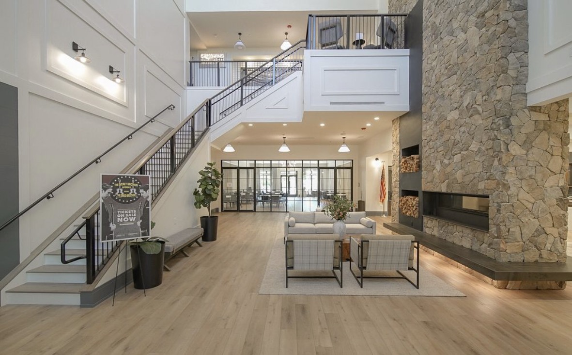 Club Cresswind two-story lobby with stone fireplace and seating