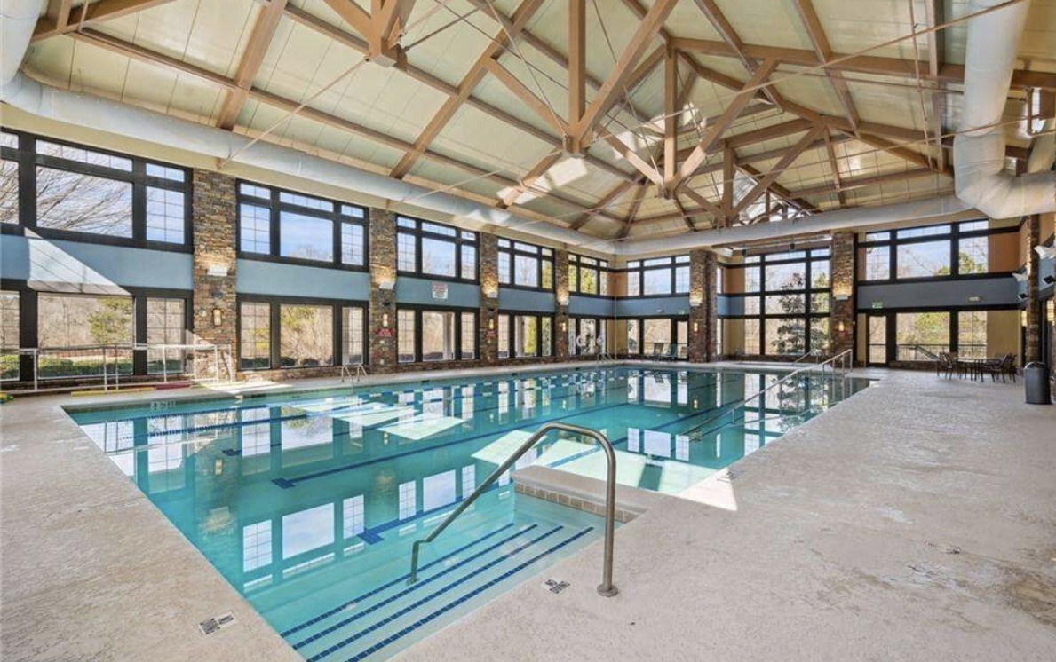 Indoor heated lap pool with timber-frame ceiling