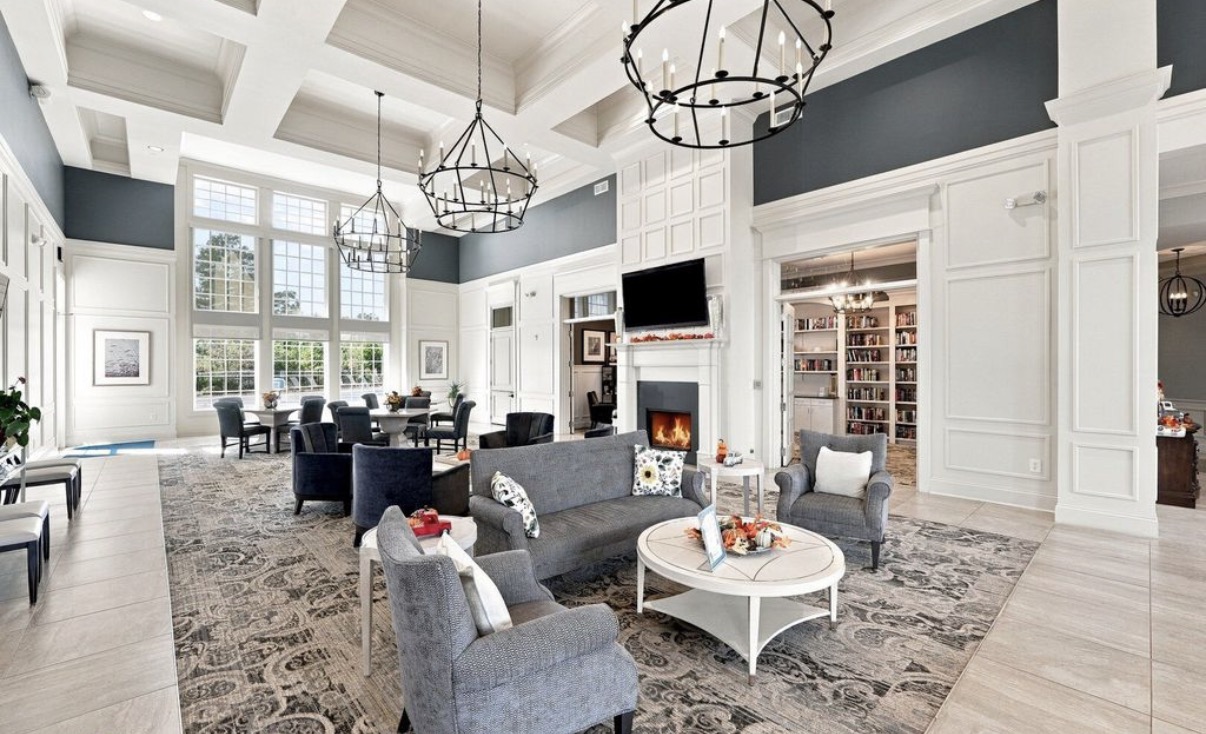 Clubhouse lounge with fireplace and library at Del Webb Chateau Elan